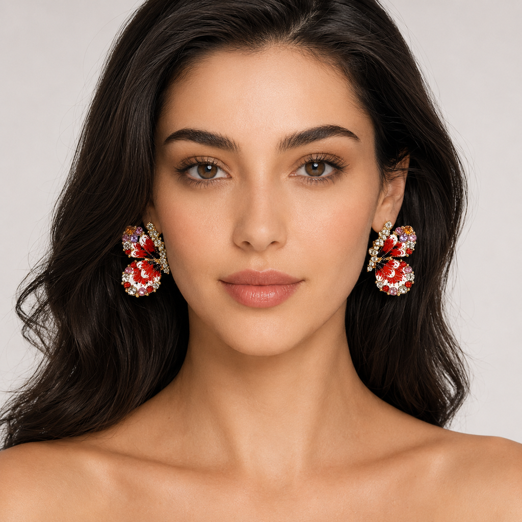 Woman wearing red butterfly statement earrings