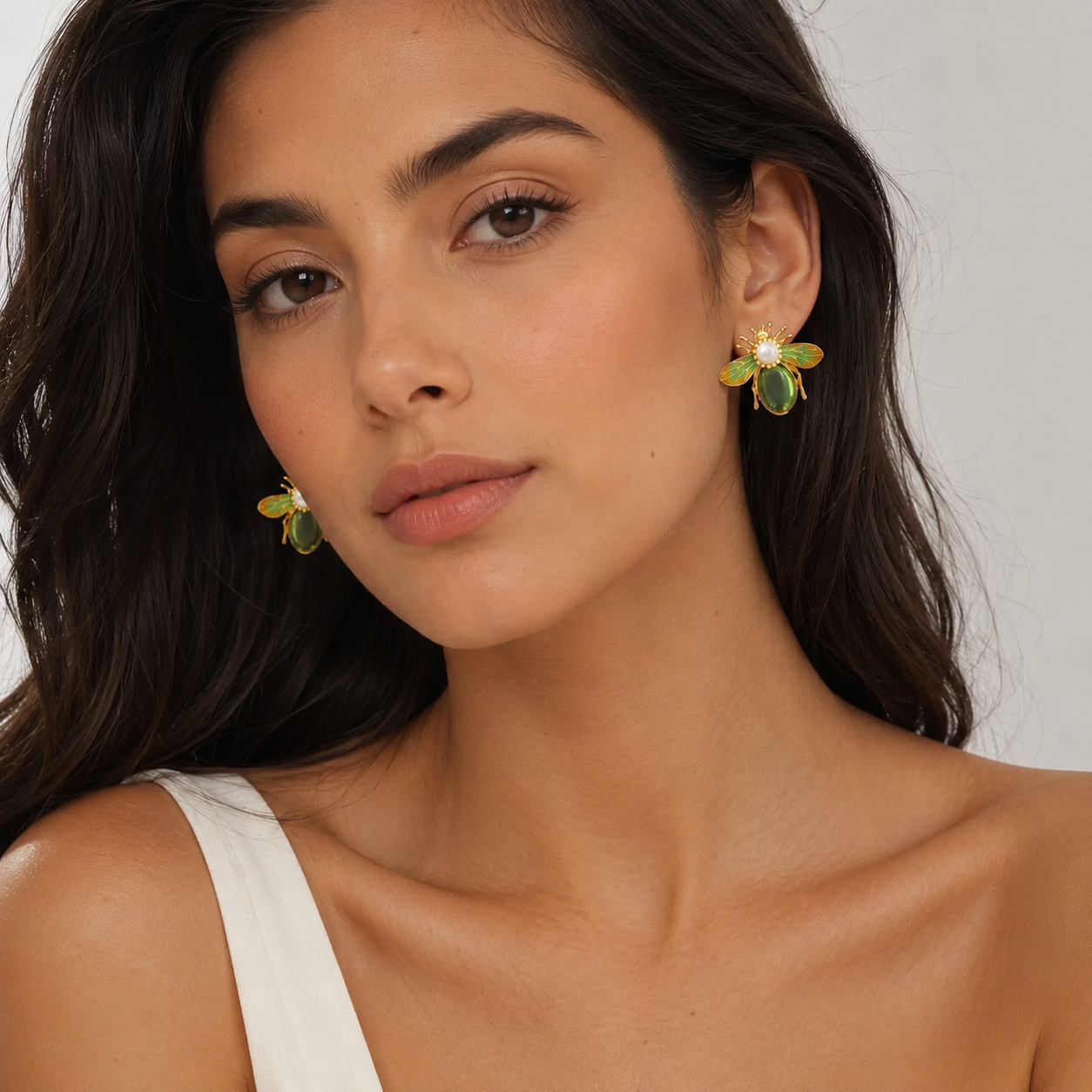 Model styling green and gold bee earrings