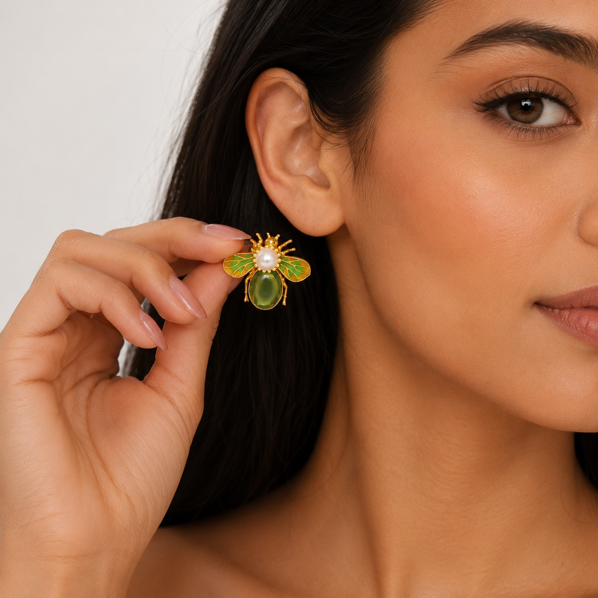 Model styling green and gold bee earrings